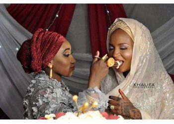 First wife feeds her husband’s second wife on their wedding day